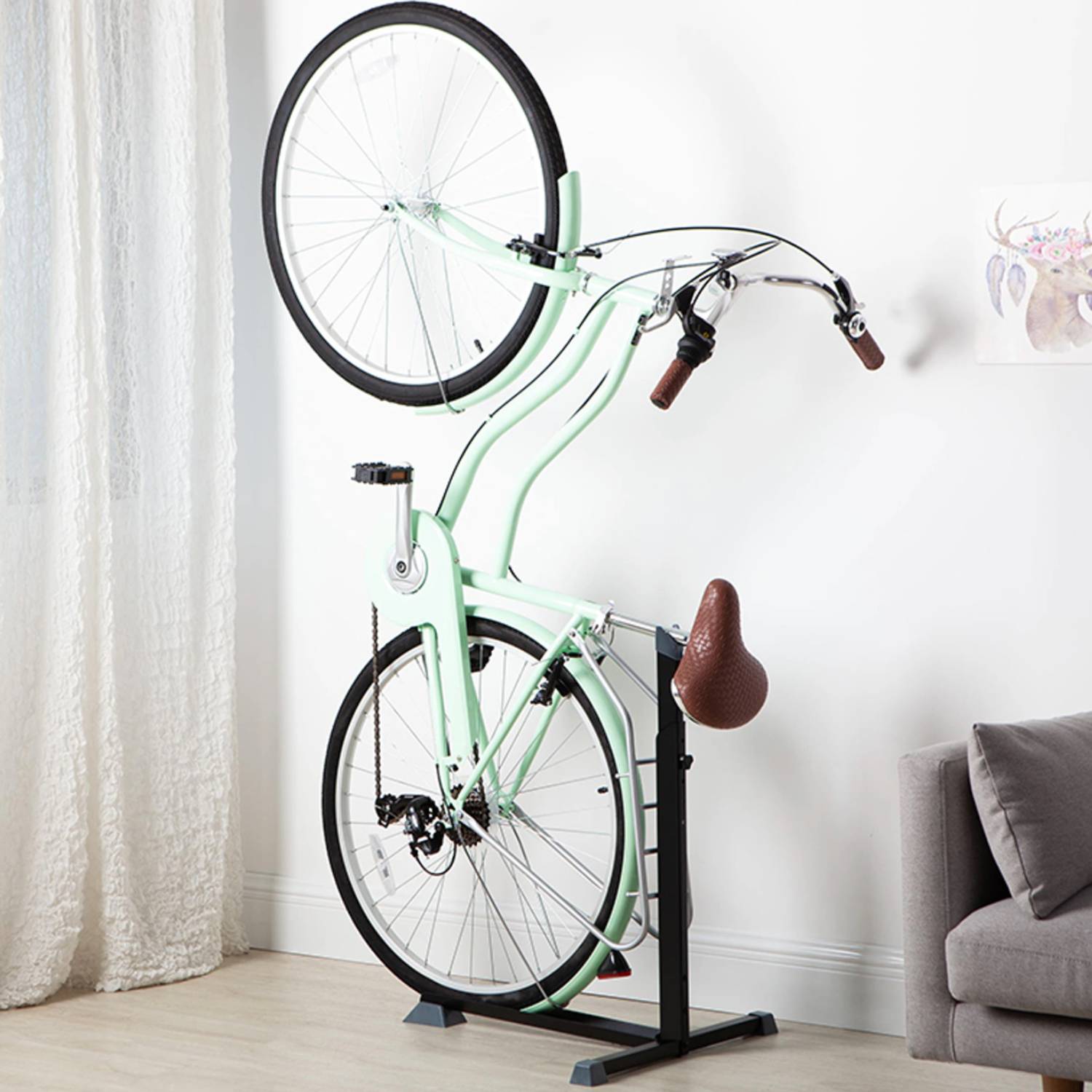 An upright bike stand holding a bike by its rear wheel