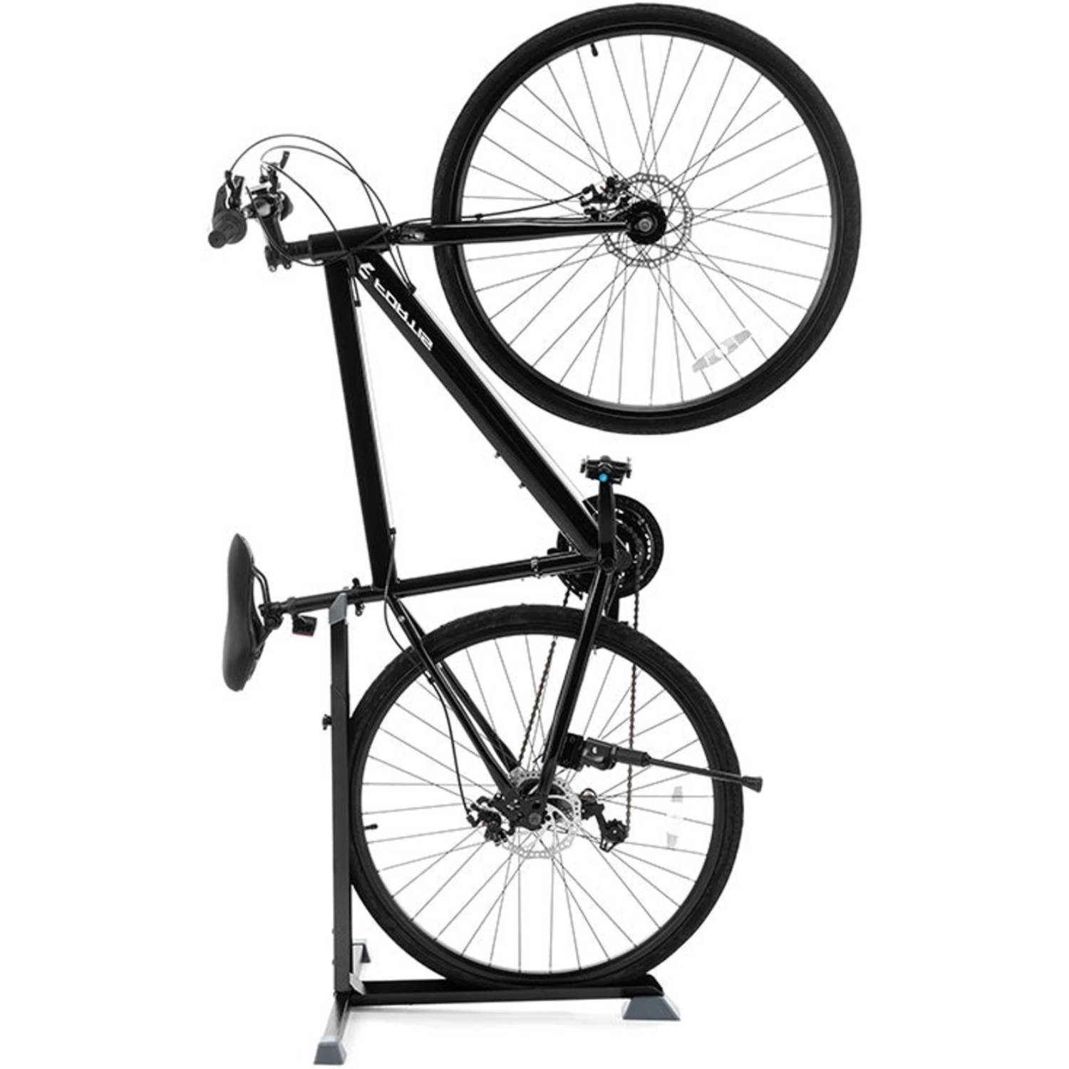 A bicycle standing upright on a vertical bike stand beside a garage wall